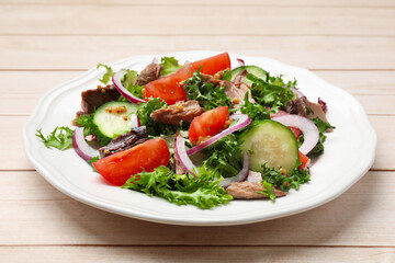Delicious fresh tuna salad on wooden table, closeup