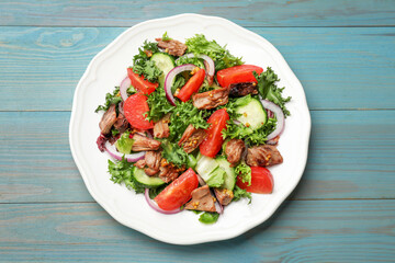 Delicious fresh tuna salad on light blue wooden table, top view