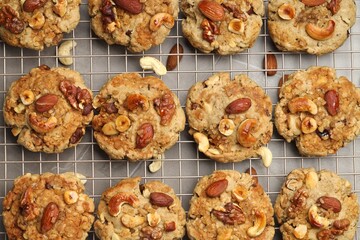 Tasty cookies with nuts on gray table, top view