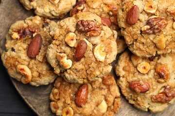 Tasty cookies with nuts on table, top view