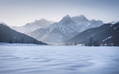Tatra Mountains in Winter, Poland Serene winter landscape with snow-covered field and majestic mountains in the background.