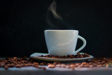 Coffee cup and coffee beans on black background, stock photo