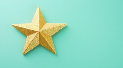 Fototapeta premium Gold glitter star on teal background. (1)