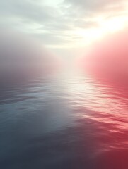 Calm ocean sunset with hazy sky.