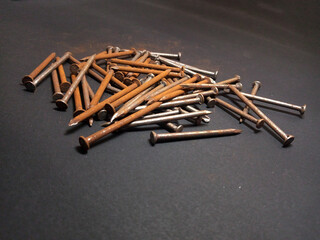 Nails scattered on the black base.