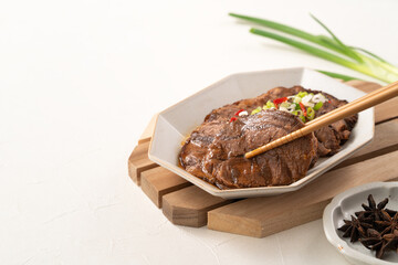 Taiwanese braised beef shank slices in a plate on white table background.