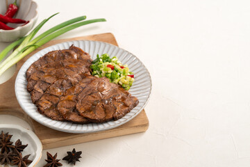 Taiwanese braised beef shank slices in a plate on white table background.