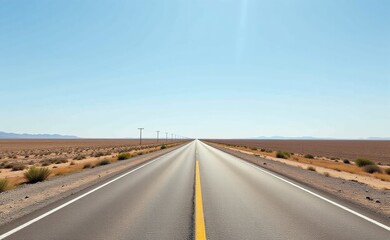 Naklejka premium A scenic road winds through a dramatic desert landscape, with towering red rock cliffs and a clear blue sky in the background.