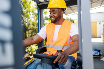 Interracial forklift driver in working uniform driving forklift outside of storage.