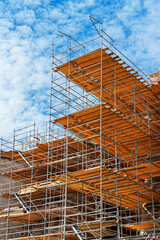 scaffolding against the sky, for repairing the exterior of buildings, or on a construction site