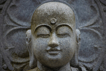 A religious stone statue of Jizo at Japanese buddhism temple