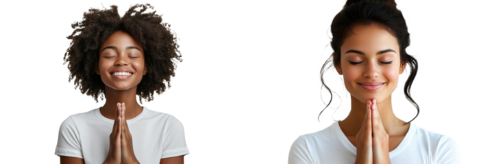 Smiling, a young Christian woman folds her hands together in prayer.