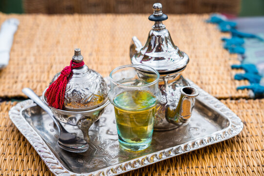 Silver moroccan tea pot and mint tea in a glass, Marrakesh, Morocco