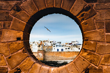 Essaouira old walled town at sunset from porthole, Morocco