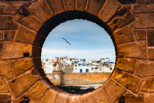 Essaouira old walled town at sunset from porthole, Morocco