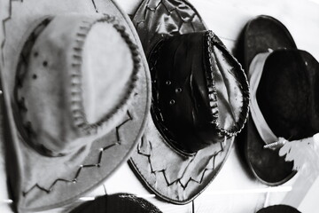 A collection of hats hangs on a wall.