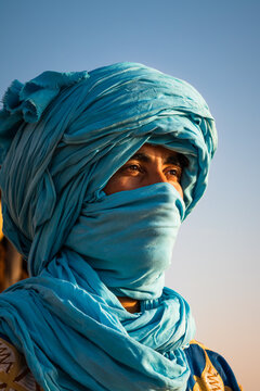 Portrait of berber man with blue turban in the desert, Morocco