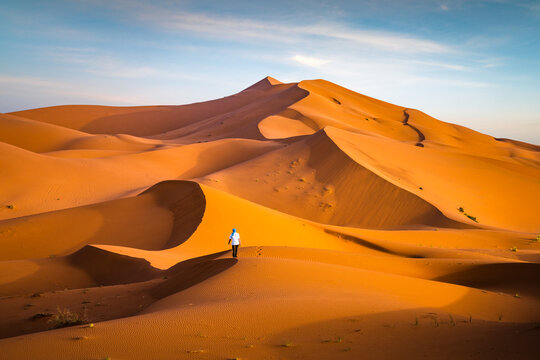 Man walking alone on the sand dune, Sahara desert, Merzouga, Morocco