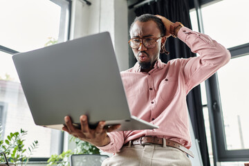 Young african american man working as a digital nomad in a modern coworking space