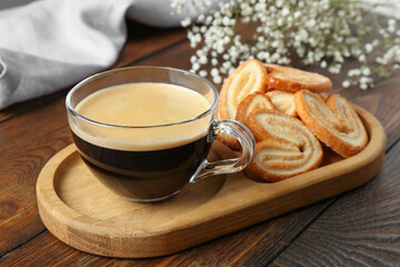 Tasty french palmier cookies and coffee on wooden table, closeup