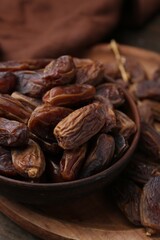 Tasty dried dates on wooden table, closeup