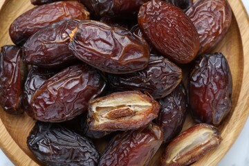 Many tasty dried dates on table, top view
