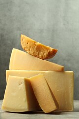 Different types of cheese on grey table