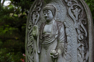 A religious stone statue of Medicine Buddha at Japanese buddhism temple