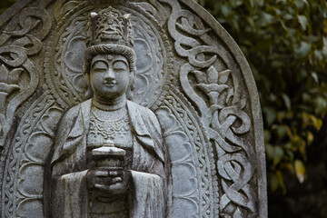 A religious stone statue of Maitreya at Japanese buddhism temple