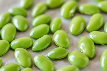 Fresh edamame beans drying on parchment paper, kitchen background, food photography
