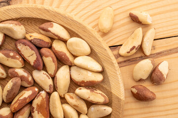 Brazil nut with homemade kitchen utensils, macro, isolated on white background and top view.
