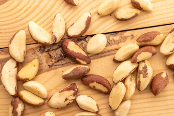 Brazil nut with homemade kitchen utensils, macro, isolated on white background and top view.