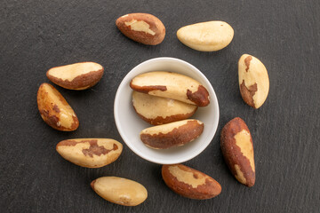 Obraz premium Brazil nut with homemade kitchen utensils, macro, isolated on white background and top view.