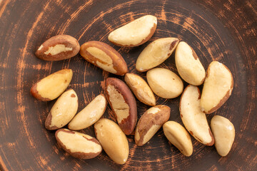Brazil nut with homemade kitchen utensils, macro, isolated on white background and top view.