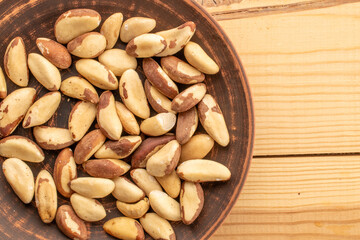 Brazil nut with homemade kitchen utensils, macro, isolated on white background and top view.