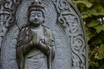 A religious stone statue of Bodhisattva Samantabhadra at Japanese buddhism temple