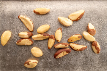 Brazil nut with homemade kitchen utensils, macro, isolated on white background and top view.