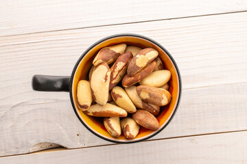 Brazil nut with homemade kitchen utensils, macro, isolated on white background and top view.