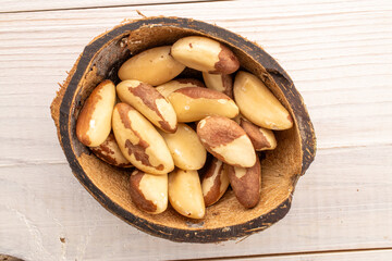 Brazil nut with homemade kitchen utensils, macro, isolated on white background and top view.