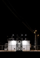 View of an electric substation at night, studio photography, with white tones