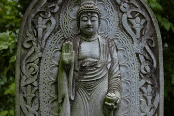 A religious stone statue of Medicine Buddha at Japanese buddhism temple