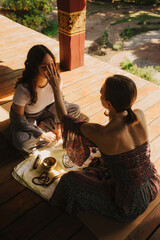Close up of female mentor and student before Mindful meditation and yoga in the gazebo....