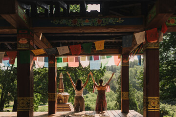 Close up of female mentor and student before Mindful meditation and yoga in the gazebo....