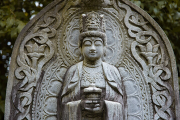 A religious stone statue of Maitreya at Japanese buddhism temple