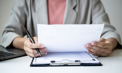 Executive CEO businesswoman checking job applicant documents resumes, interviews, and signing to approve the contract in the office room