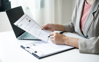 Executive CEO businesswoman checking job applicant documents resumes, interviews, and signing to approve the contract in the office room