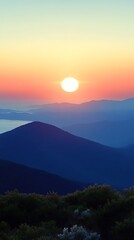 Sunrise over layered mountains.