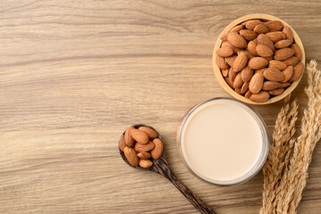 Almond milk in cup glass on wooden table, Alternative milk made from plant, non dairy