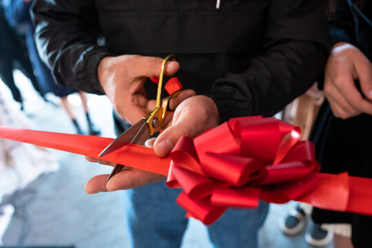 The opening of a house or a store, the moment of cutting the red ribbon