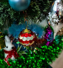 Christmas toys on an artificial Christmas tree close-up